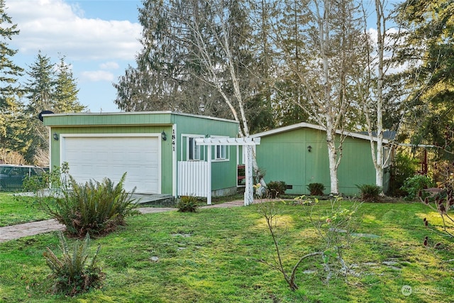 garage featuring a yard