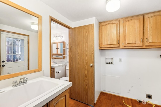 bathroom featuring hardwood / wood-style flooring, sink, and toilet