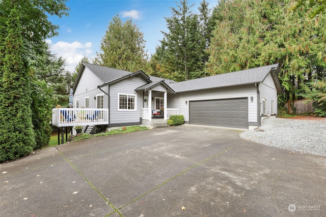 ranch-style house featuring a garage and a deck