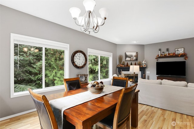 dining area featuring an inviting chandelier and light hardwood / wood-style floors