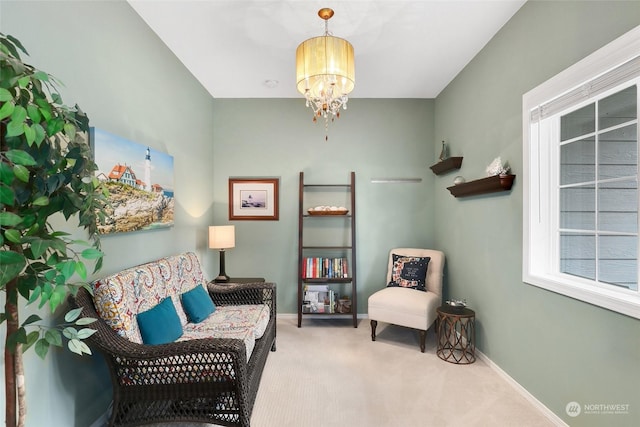 sitting room featuring light carpet and a chandelier