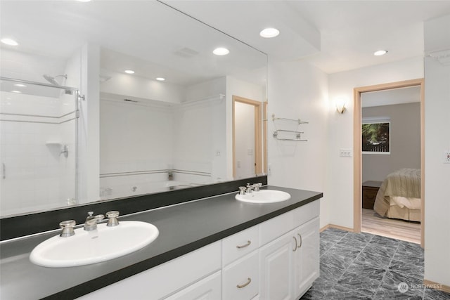 bathroom with vanity and a shower with door