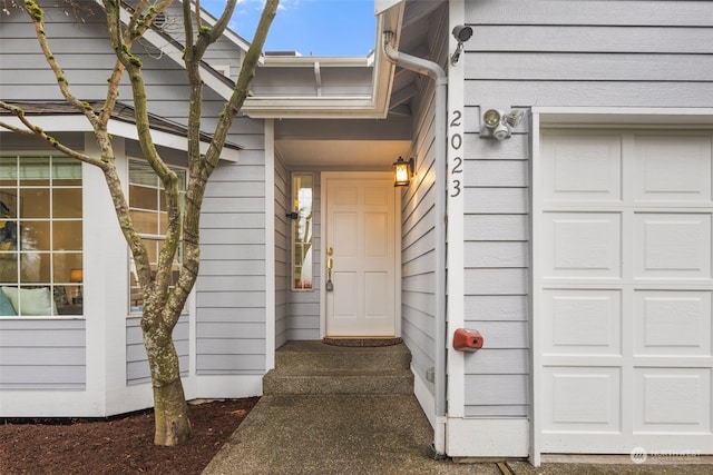 doorway to property with a garage