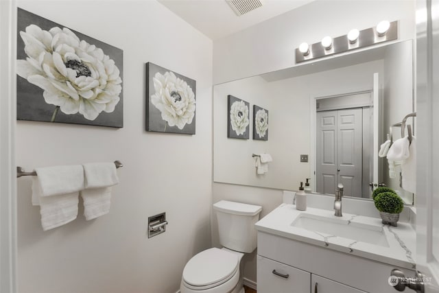 bathroom featuring toilet and vanity