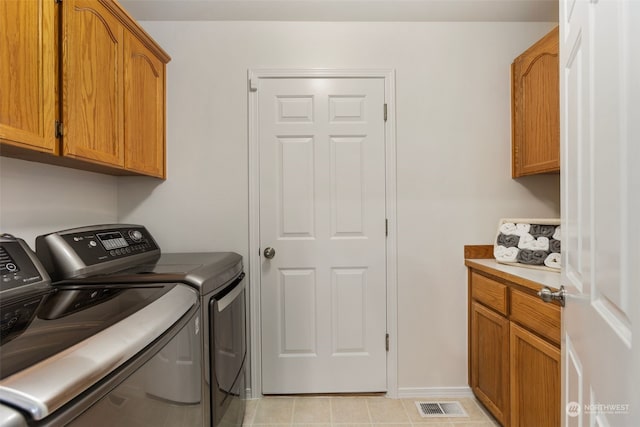 washroom with cabinets and independent washer and dryer