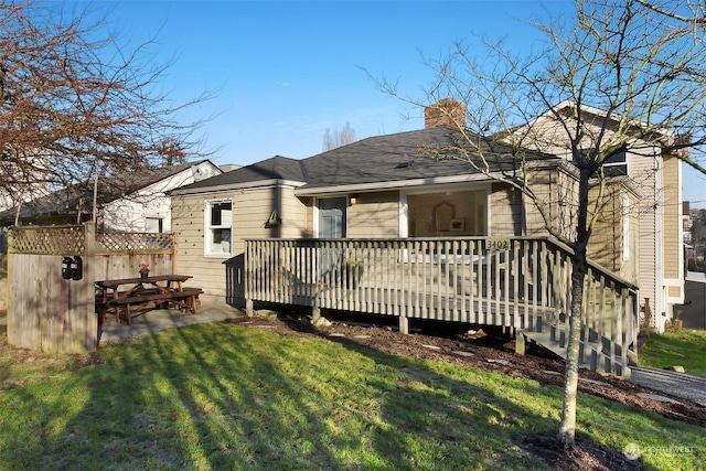 back of house with a patio, a yard, and a wooden deck