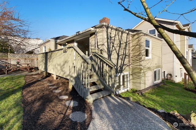 view of property exterior with a lawn