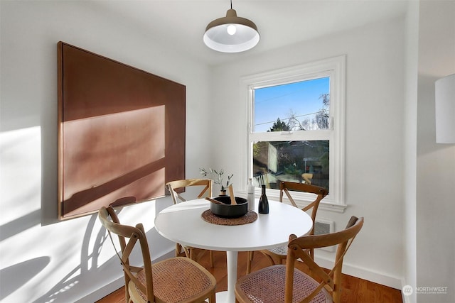 dining space with hardwood / wood-style flooring