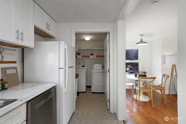 kitchen featuring white cabinetry, dishwasher, separate washer and dryer, light hardwood / wood-style flooring, and pendant lighting