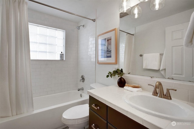 full bathroom featuring shower / tub combo with curtain, vanity, and toilet