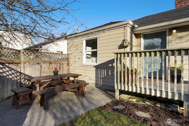 wooden terrace featuring a patio area