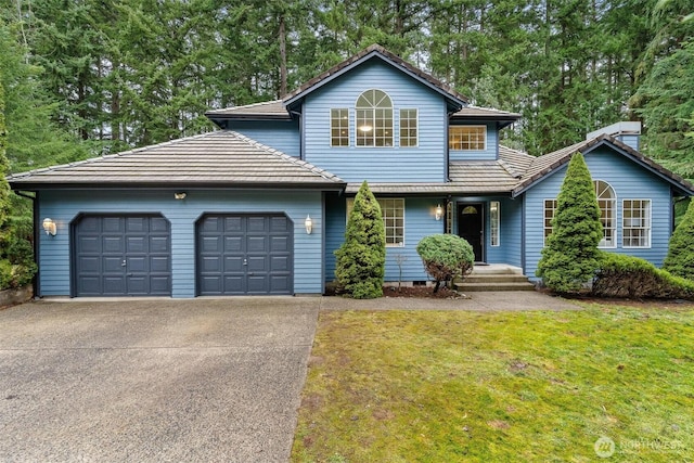 traditional home with a garage, concrete driveway, a tiled roof, crawl space, and a front yard