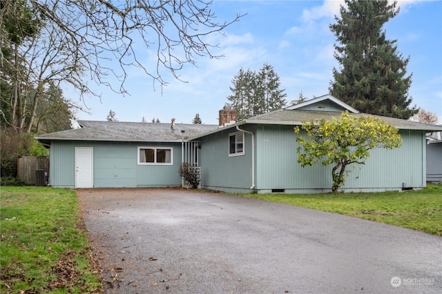 view of front facade with a front yard and central AC unit