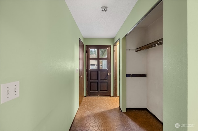 entryway with a textured ceiling