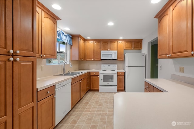 kitchen featuring sink and white appliances