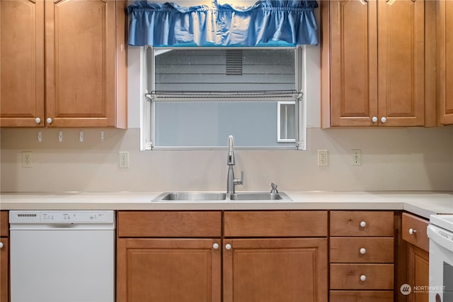 kitchen with white dishwasher, sink, and range