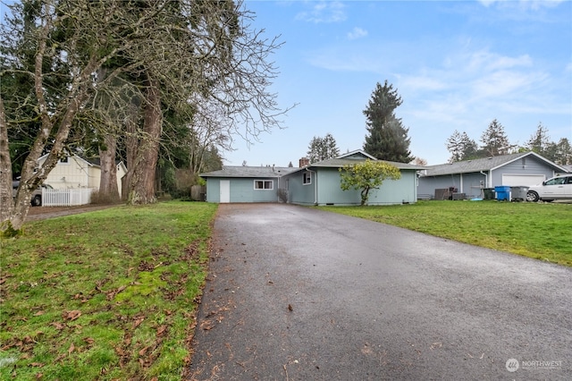 ranch-style home with a garage and a front yard