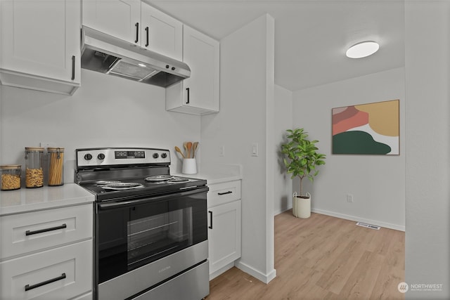 kitchen with white cabinetry, light hardwood / wood-style floors, and stainless steel electric stove