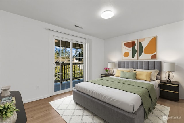 bedroom with access to exterior and wood-type flooring