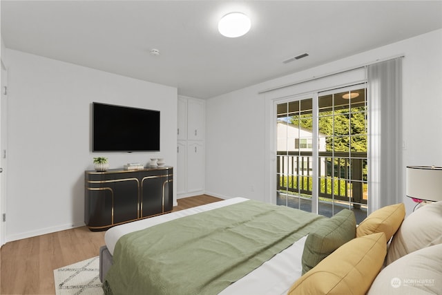 bedroom featuring hardwood / wood-style floors and access to outside