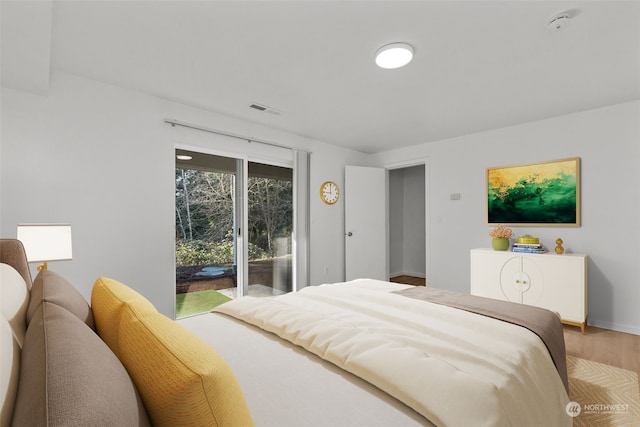 bedroom featuring hardwood / wood-style floors and access to outside