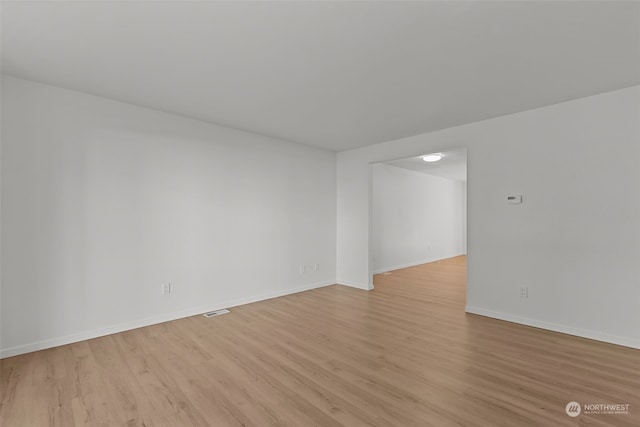 spare room with light hardwood / wood-style flooring