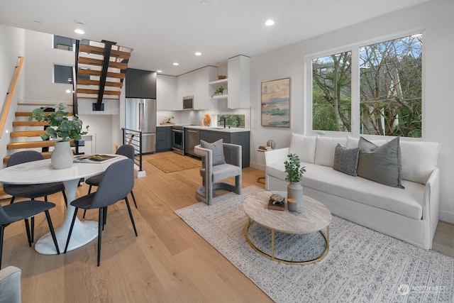 living room featuring sink and light hardwood / wood-style floors