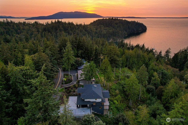 aerial view at dusk with a water and mountain view