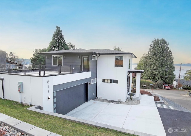 view of front facade with a balcony and a garage