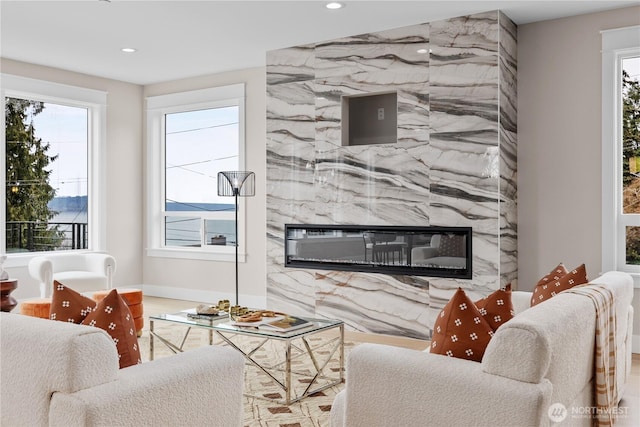 living room featuring recessed lighting and a premium fireplace