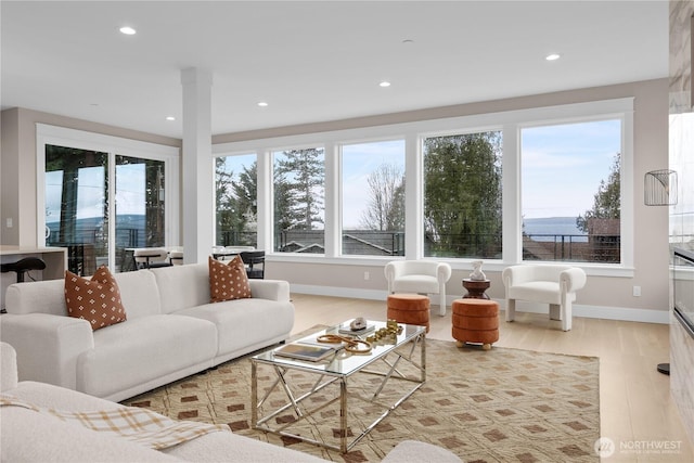 living area featuring recessed lighting, baseboards, and wood finished floors