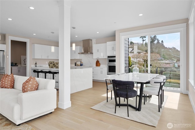 dining area featuring recessed lighting and light wood-type flooring