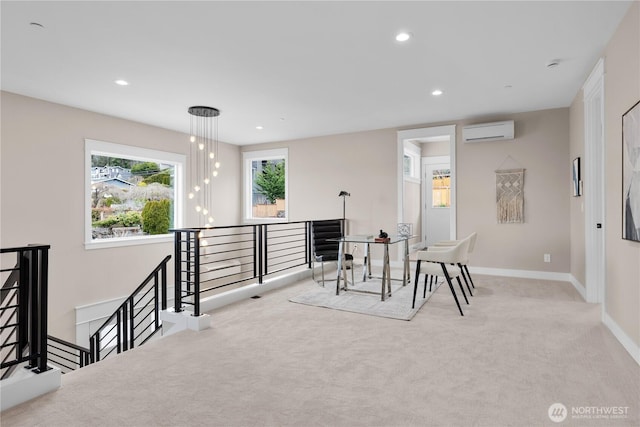 living area with an upstairs landing, a wall unit AC, recessed lighting, carpet, and baseboards