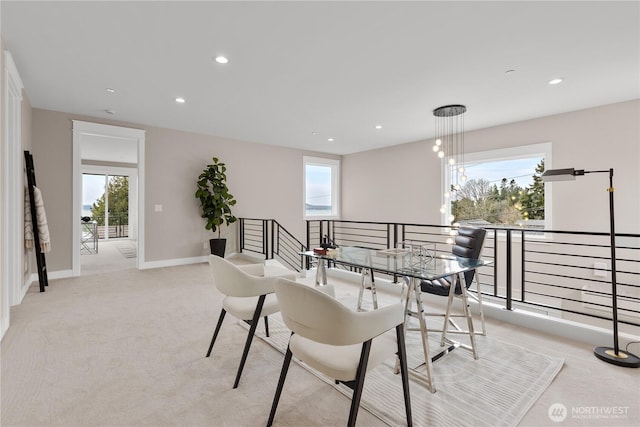 carpeted dining area featuring recessed lighting, baseboards, and a healthy amount of sunlight