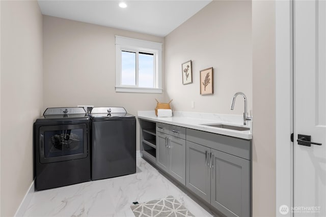 clothes washing area with recessed lighting, cabinet space, a sink, marble finish floor, and washer and clothes dryer