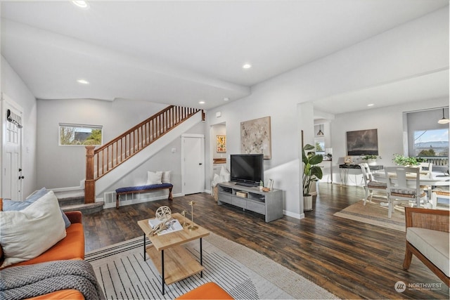 living room featuring plenty of natural light and dark hardwood / wood-style flooring