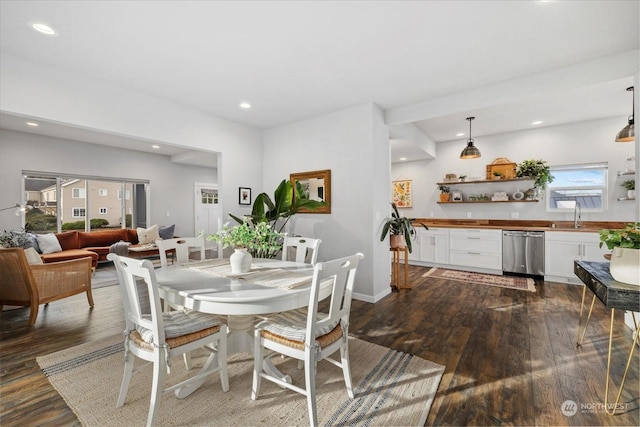 dining room with dark wood-type flooring and sink