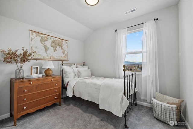 carpeted bedroom with vaulted ceiling