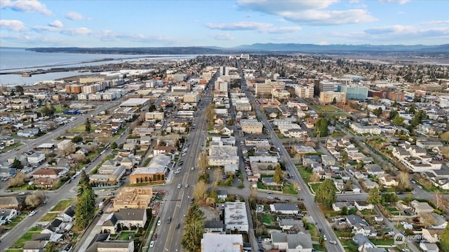 drone / aerial view featuring a water and mountain view