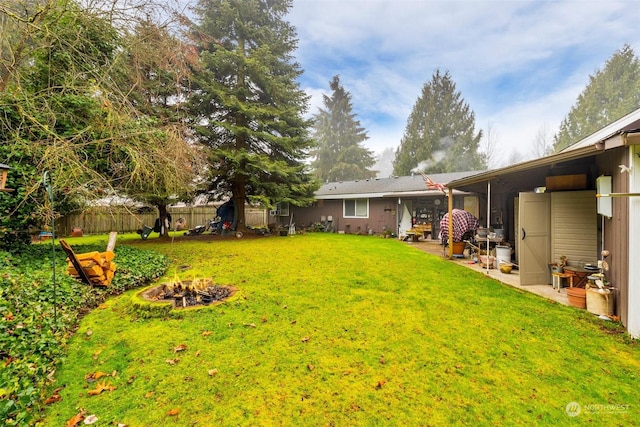 view of yard featuring an outdoor fire pit and a patio area