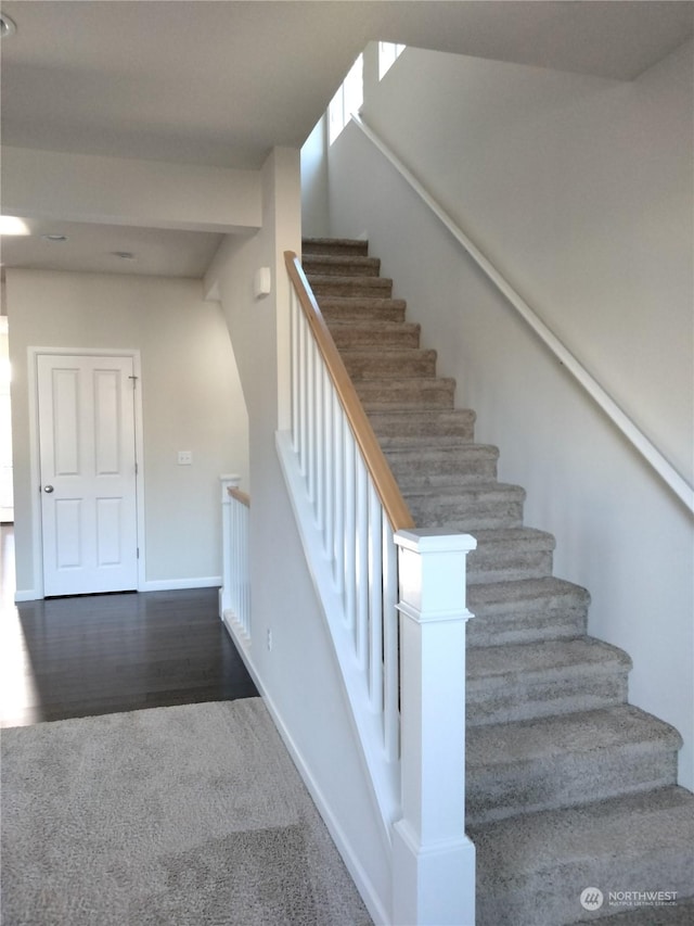 stairway with hardwood / wood-style floors