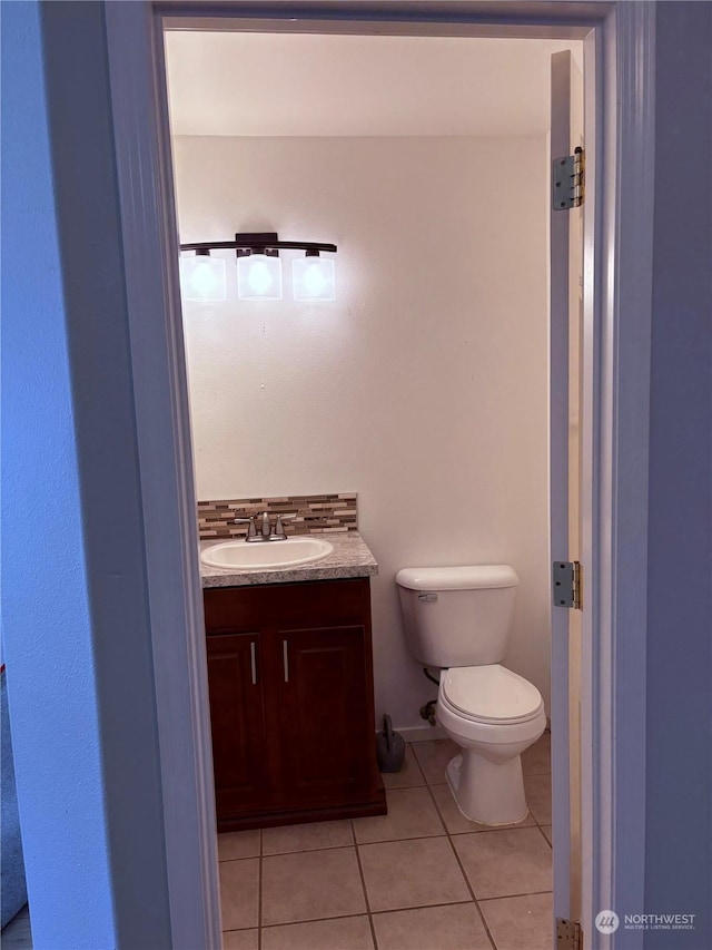 bathroom with vanity, toilet, and tile patterned floors