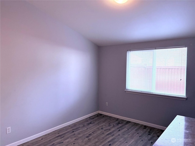 empty room with dark hardwood / wood-style floors