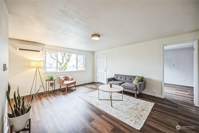 living room with a wall unit AC and dark wood-type flooring