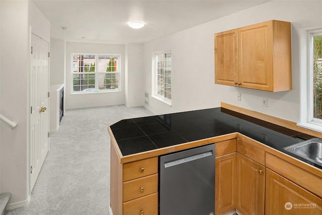 kitchen featuring black dishwasher, tile counters, sink, kitchen peninsula, and light colored carpet