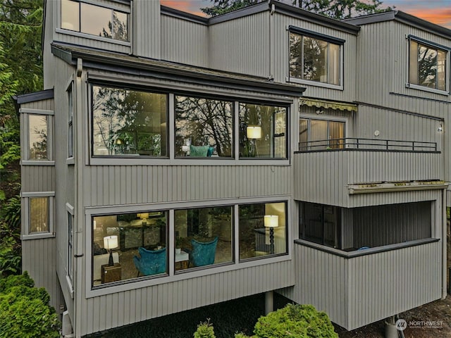 view of back house at dusk