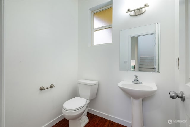 bathroom featuring wood-type flooring, sink, and toilet