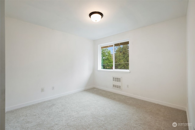 unfurnished room with light carpet