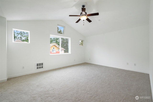 carpeted empty room featuring ceiling fan and vaulted ceiling