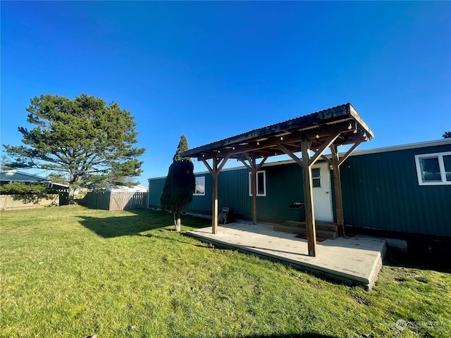 rear view of house featuring a patio area and a lawn